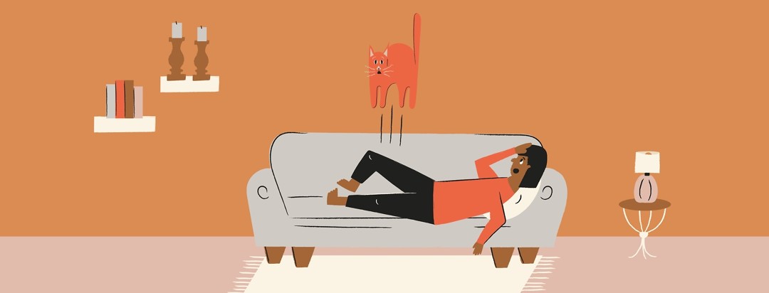 a woman with restless legs syndrome laying on a couch and accidentally jerking her cat off of her legs