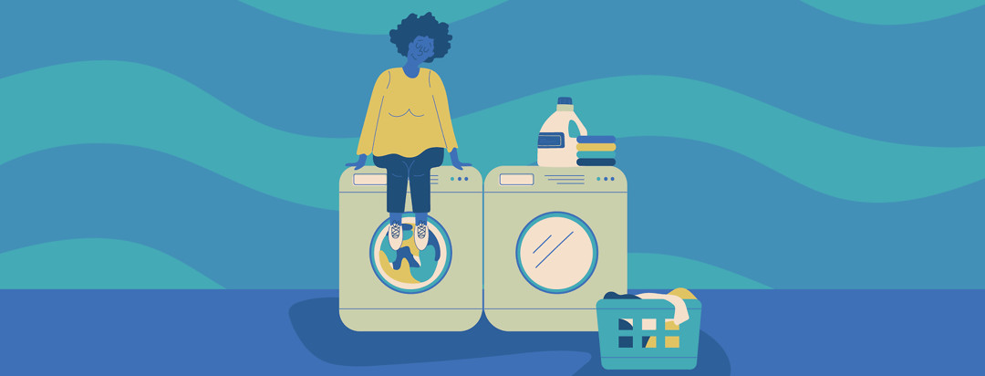 a woman sitting on top of her washing machine as its running