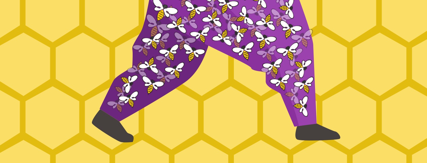 Legs filled with buzzing bees walking in front of honeycomb.