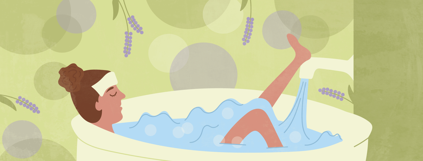 a woman soaking in a bathtub with a washcloth on her forehead and surrounded by lavender