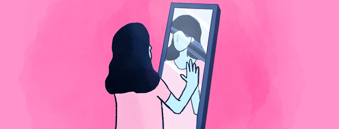a woman standing in front of a mirror with her hand on her reflection