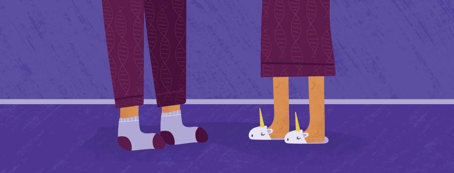 the feet of a mother and a daughter, both in pajamas that have DNA strand patterns on them